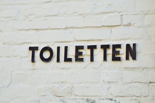 Metal letters indicate a toilet