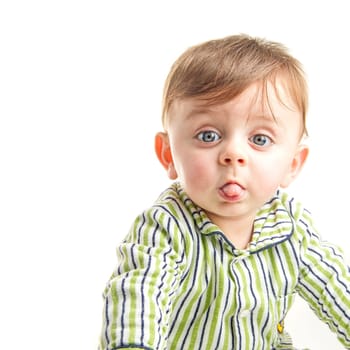 Baby grimacing to the camera on white background