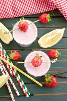 Milkshake in glaes with fresh strawberries