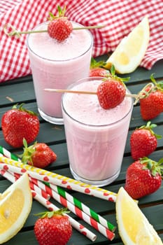 Milkshake in glaes with fresh strawberries
