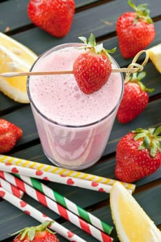 Milkshake in glaes with fresh strawberries