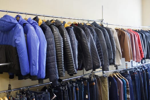 all sorts of clothes hanging in shop