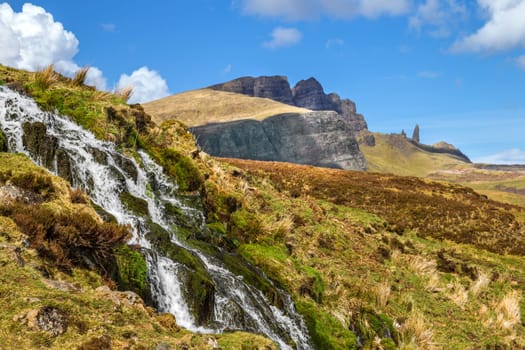 Waterfall with a view of the Old man of storr