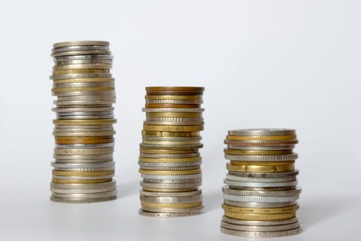 three towers of coins isolated on a whiteness