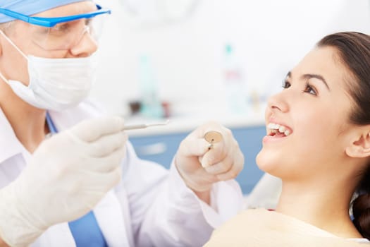 Young girl with open mouth before oral checkup at the dentist’s