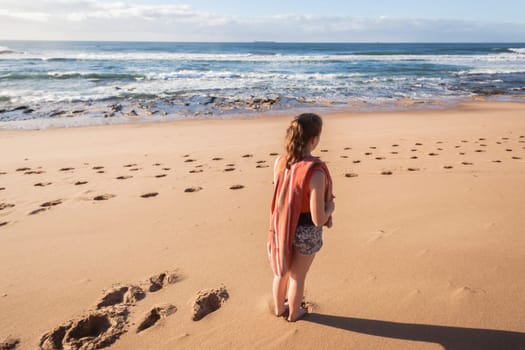 Girl teenager daughter exploring ocean beach sand rock reefs pools at low tide