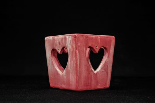 Colorful designed clay vase over a Black background