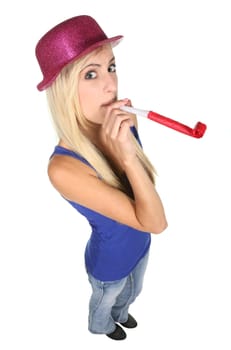 Beautiful party girl in shiny hat and blowing party toy - isolated on white