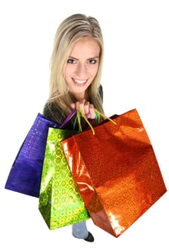 Lovely blond shopping lady holding colorful bags - isolated