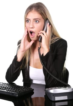 Pretty blond office secretary lady talkiing on telephone with shocked expression on her face