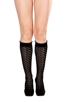 female legs in fishnet socks and shoes on high heels in the studio on a white background