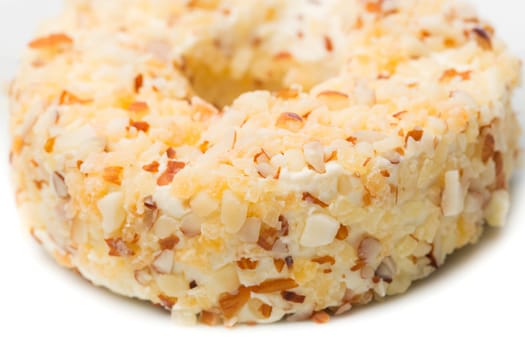 Round sweet dessert cheese with nuts and pineapple closeup.