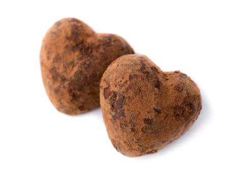 Two candy truffle heart shaped. Isolate on white. Symbols of Valentine's Day.