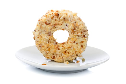 Round sweet dessert cheese with nuts and pineapple. On the plate.