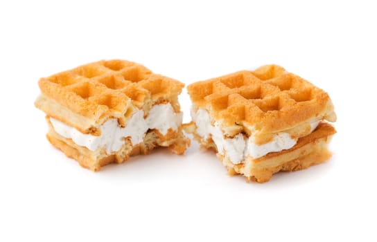 Waffle with cream a broken in half. Isolate on white.