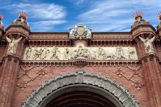 Arc de Triomphe Barcelona closeup against a blue sky with clouds