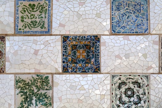Detail of a mosaic on the wall. Close-up of the ceramics in Park Guell Barcelona created by Gaudi