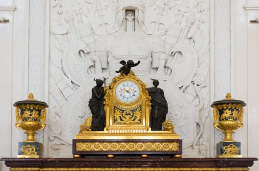 Antique clock in gold case in the interior Hermitage Museum, St. Petersburg.