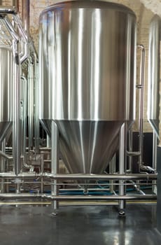Stainless steel tank at the brewery for the fermentation of beer.