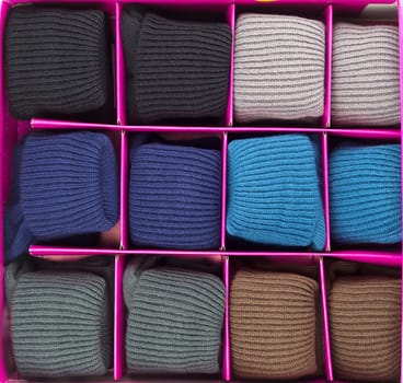 Warm socks rolled up in a box in the branches.