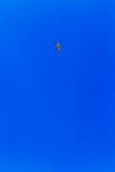Helicopter in the air across clear sky