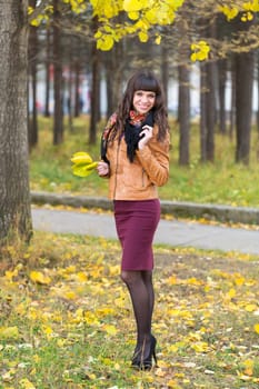Slim pretty girl in an autumn forest, full length portrait