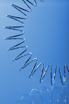 Chrome spiral bent on blue background