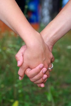 Hand in a hand on a green background