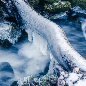 Frozen icicles on water flow