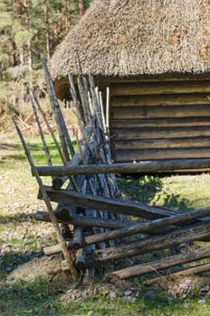 Old rural building with a roof covered by straw, close-up