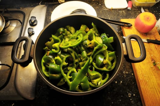 Coocking Green Chili Pepperson a Black Pot
