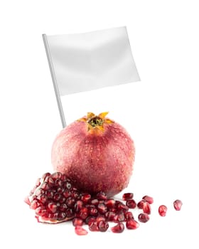 Healthy and organic food concept. Fresh Ripe pomegranate fruit and part with flag showing the benefits or the price of fruits.