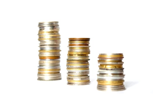 three towers of coins isolated on a whiteness