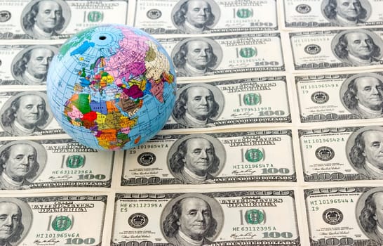 A globe and dollars is isolated on a whiteness