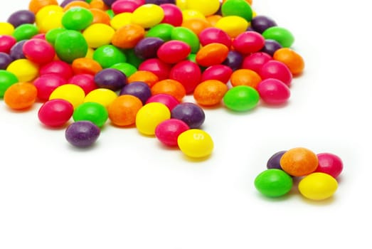 Set of sweet dragees of different color on white background