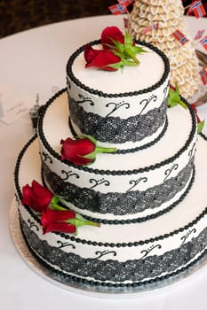 A wedding cake sits waiting to be enjoyed at the reception