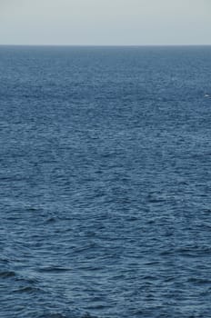 Blue Still Sea Water With Ripple. Natural Background Photo Texture