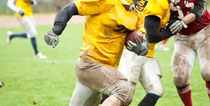American football game in rain