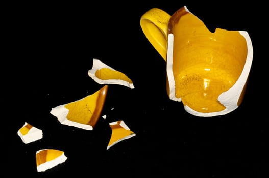 Broken Orange Coffee Cup on A Black Bacground