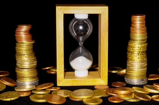 Buisness Time Concept Hourglass and Money on a Black Background