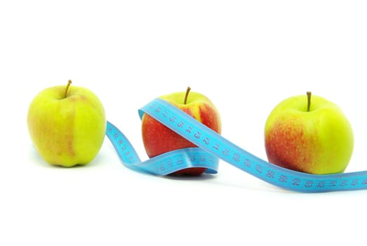 yellow apple and measuring tape on white