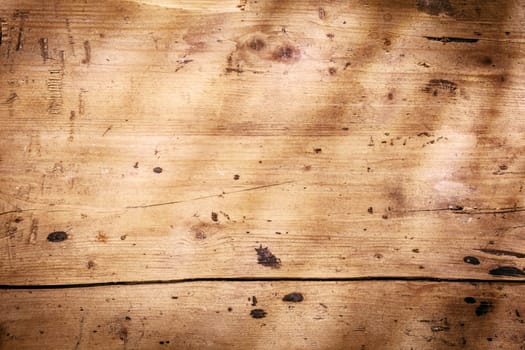 Vintage wooden background texture with worn smooth planks with stains and a vignette in the form of shadows