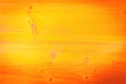 Wood background texture in the 2104 fall or autumn color trend in a rich shade of orange with uneven light vignetting and central copyspace