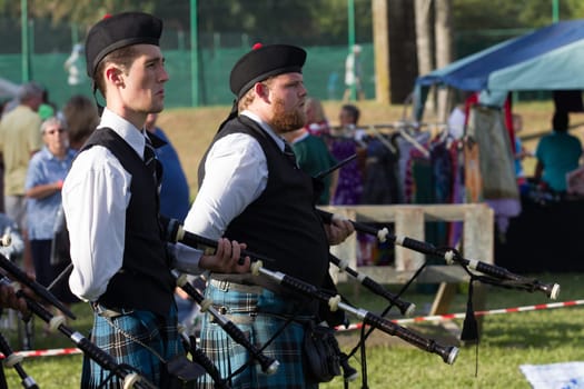 Scottish bands men and women play musical instruments in traditional Scottish clan colors dress at the Scottish Highland Gathering in Toti Durban South Africa