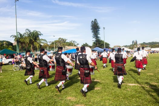 Scottish bands men and women play musical instruments in traditional Scottish clan colors dress at the Scottish Highland Gathering in Toti Durban South Africa