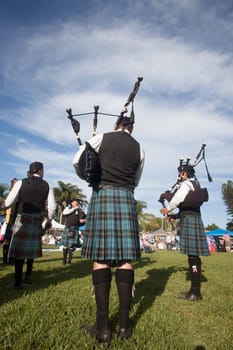 Scottish bands men and women play musical instruments in traditional Scottish clan colors dress at the Scottish Highland Gathering in Toti Durban South Africa