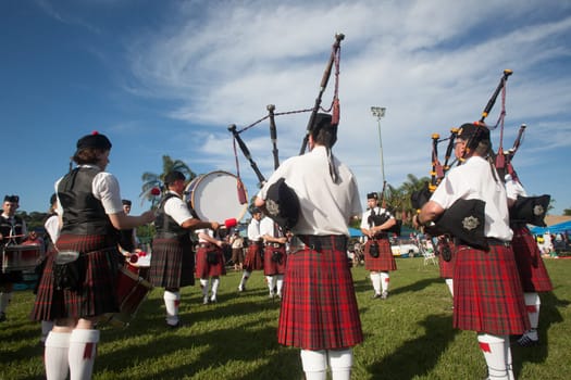 Scottish bands men and women play musical instruments in traditional Scottish clan colors dress at the Scottish Highland Gathering in Toti Durban South Africa