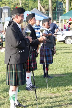 Scottish bands men and women play musical instruments in traditional Scottish clan colors dress at the Scottish Highland Gathering in Toti Durban South Africa