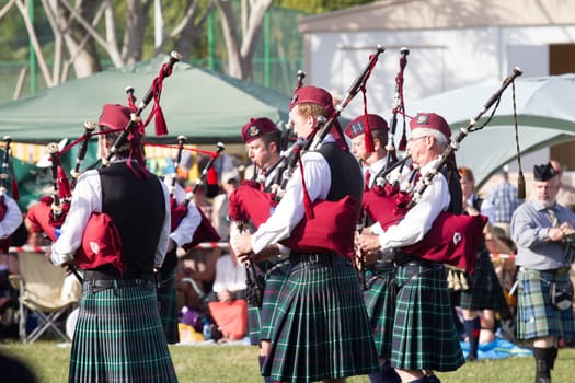 Scottish bands men and women play musical instruments in traditional Scottish clan colors dress at the Scottish Highland Gathering in Toti Durban South Africa