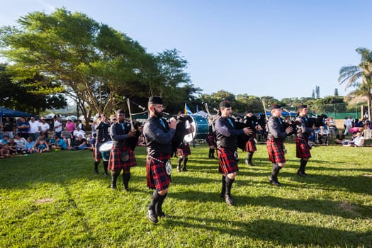 Scottish bands men and women play musical instruments in traditional Scottish clan colors dress at the Scottish Highland Gathering in Toti Durban South Africa